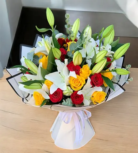 Red, Yellow Roses & White Lily Bouquet - Vibrant Floral Charm